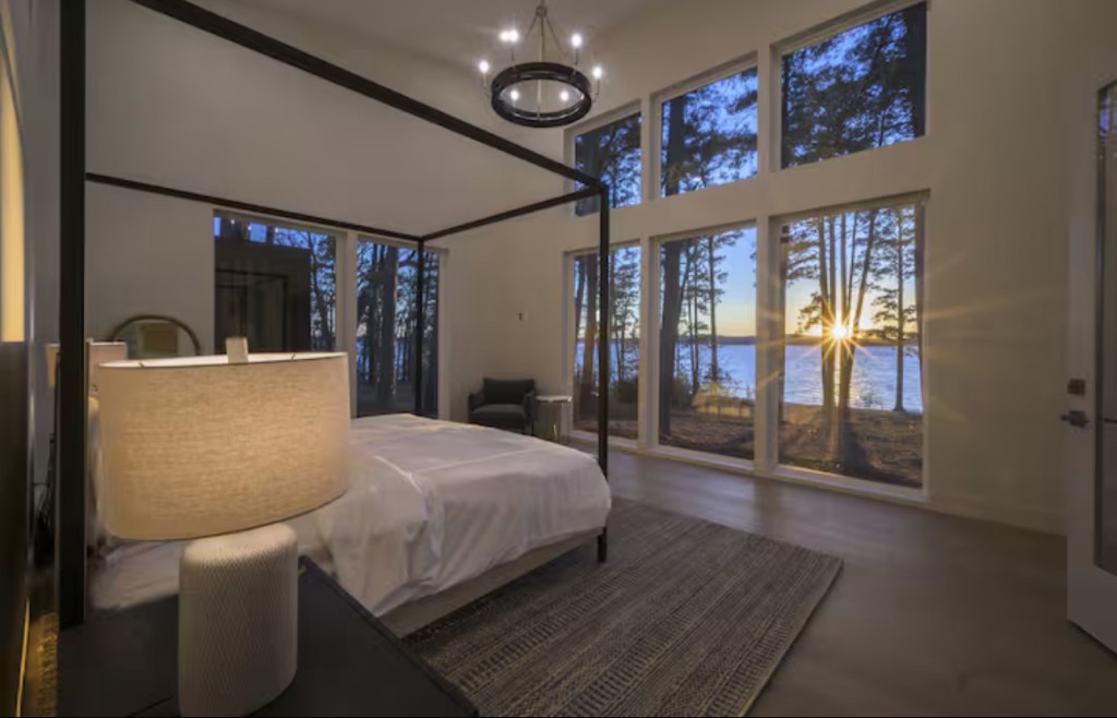 Primary bedroom with sunset over the lake