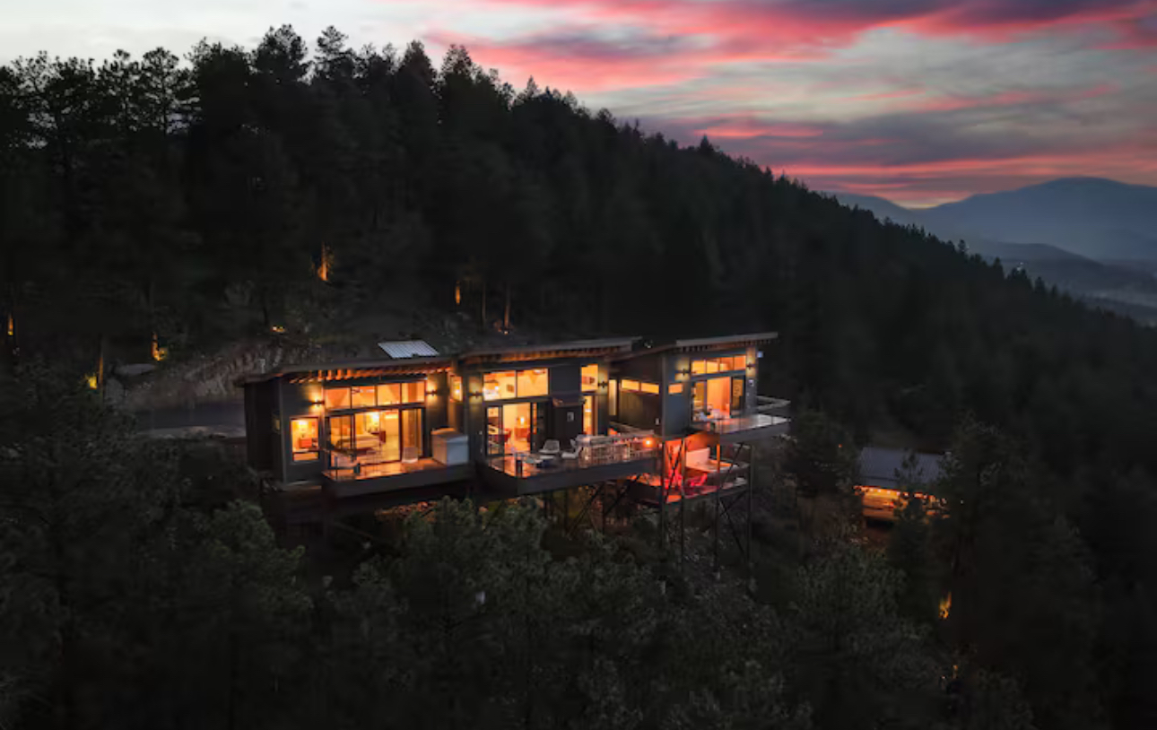 Ember Ridge hillside home glowing at dusk