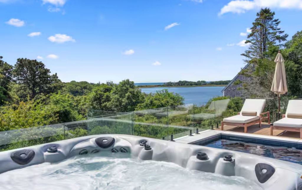 Hot tub and pool deck overlooking the water