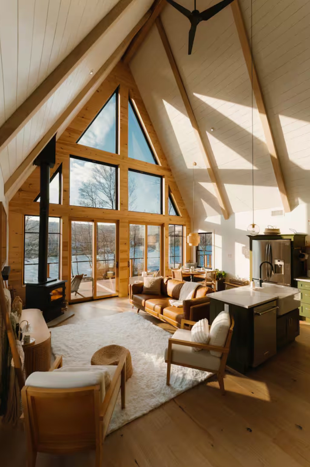 A-frame living room with wood stove and lake views